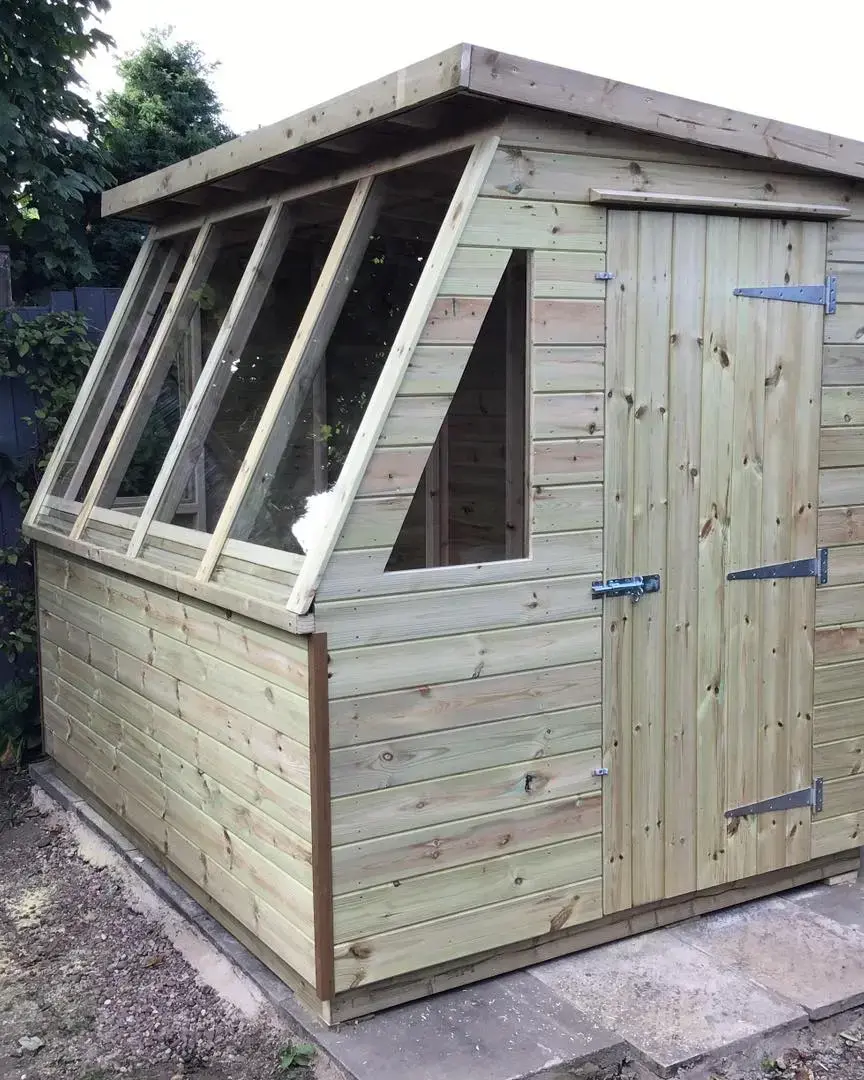 Timber garden shed with angled glazed front