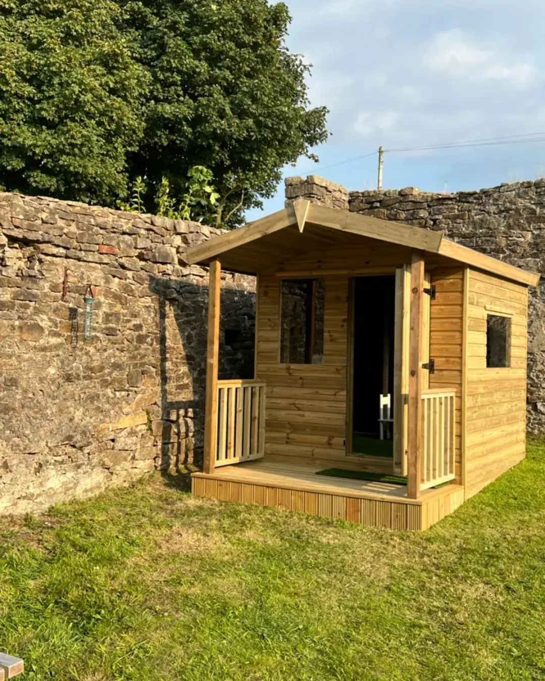 Timber playhouse with covered porch